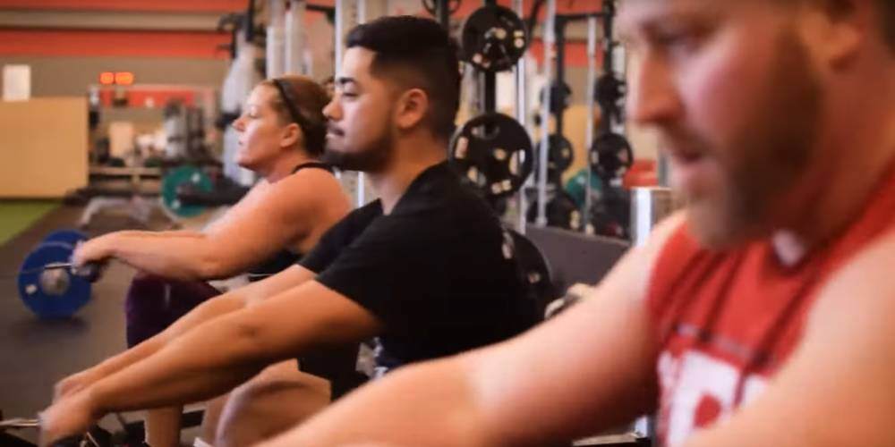 Gym members at Four Seasons fitness club on rowing machines